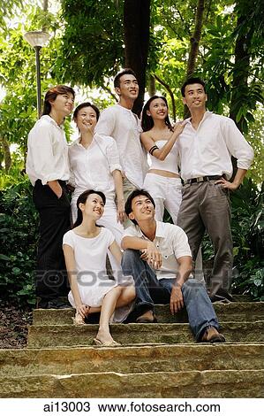 Young adults posing for camera, looking up View Large Photo Image Stock Image - Young adults posing for camera, looking up. Fotosearch