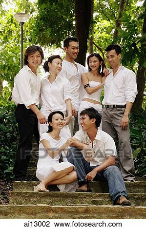 Stock Image - Young adults posing for camera. Fotosearch