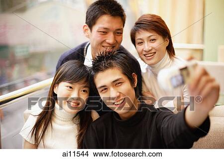 Young adults posing for photograph View Large Photo Image Picture - Young adults posing for photograph. Fotosearch
