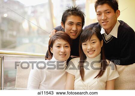 Young adults posing, looking at camera View Large Photo Image Stock Image - Young adults posing, looking at camera. Fotosearch