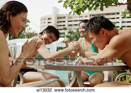 Young adults sitting around, two men wrestling View Large Photo Image Stock Image - Young adults sitting around, two men wrestling. Fotosearch