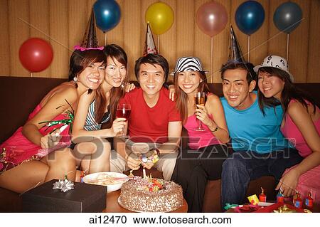 Young adults sitting side by side, looking at camera View Large Photo Image Stock Image - Young adults sitting side by side, looking at camera. Fotosearch