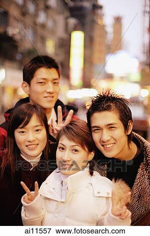 Young adults smiling at camera, urban scene View Large Photo Image Stock Photo - Young adults smiling at camera, urban scene. Fotosearch