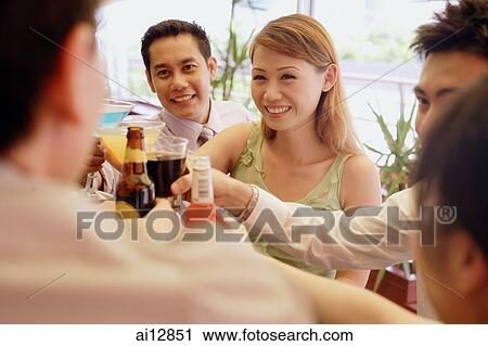 Young adults toasting with drinks View Large Photo Image Stock Image - Young adults toasting with drinks. Fotosearch