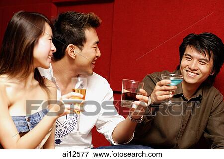 Young adults toasting with drinks View Large Photo Image Stock Photo - Young adults toasting with drinks. Fotosearch
