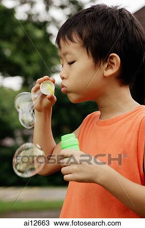 Young boy blowing bubbles View Large Photo Image Stock Image - Young boy blowing bubbles. Fotosearch