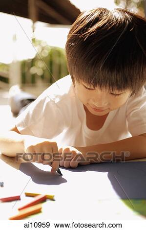 Young boy drawing with crayons View Large Photo Image Stock Photo - Young boy drawing with crayons. Fotosearch