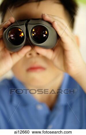 Young boy looking through binoculars View Large Photo Image Stock Image - Young boy looking through binoculars. Fotosearch