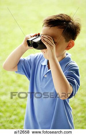 Young boy looking through binoculars View Large Photo Image Stock Photo - Young boy looking through binoculars. Fotosearch