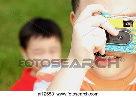 Young boy looking through camera View Large Photo Image Stock Image - Young boy looking through camera. Fotosearch