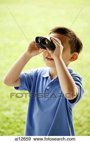 Young boy using binoculars View Large Photo Image Stock Photo - Young boy using binoculars. Fotosearch