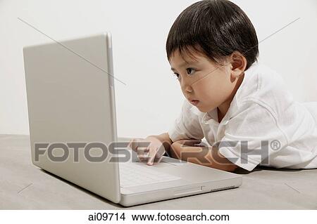 Young boy using laptop View Large Photo Image Picture - Young boy using laptop. Fotosearch