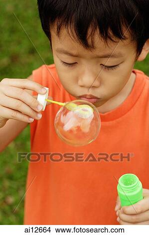 Young boy with bubble wand, blowing bubbles View Large Photo Image Picture - Young boy with bubble wand, blowing bubbles. Fotosearch