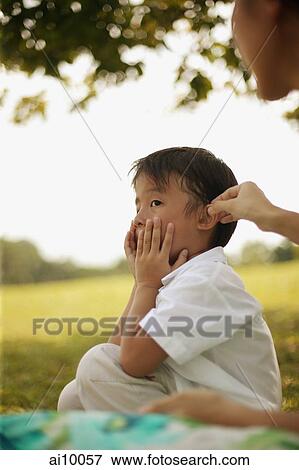 Young boy with hands on his face View Large Photo Image Stock Photo - Young boy with hands on his face. Fotosearch