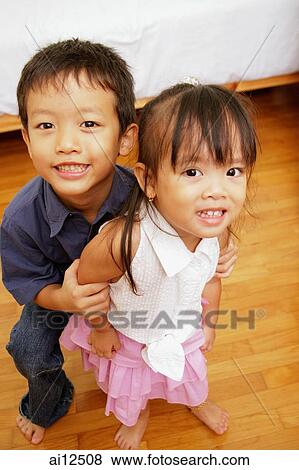 Stock Photo - Young children, looking up at camera, smiling. Fotosearch