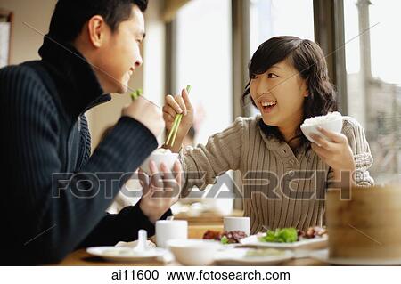 Young couple eating at a Chinese restaurant View Large Photo Image Stock Image - Young couple eating at a Chinese restaurant. Fotosearch