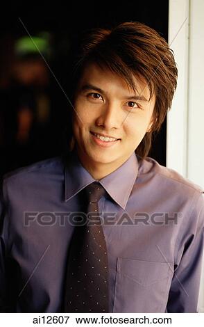 Young executive looking at camera, portrait View Large Photo Image Stock Photo - Young executive looking at camera, portrait. Fotosearch
