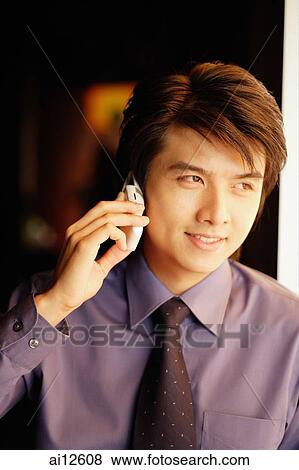 Young executive using mobile phone View Large Photo Image Stock Photo - Young executive using mobile phone. Fotosearch