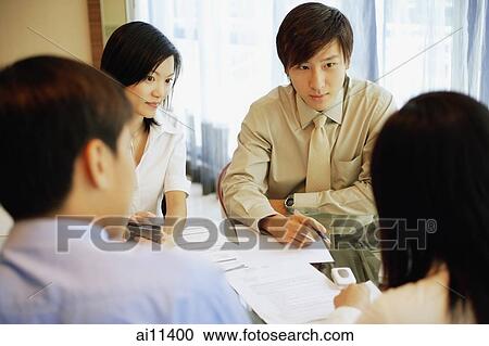 Young executives, having a meeting. View Large Photo Image Stock Image - Young executives, having a meeting.. Fotosearch