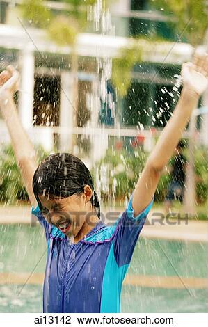 Young girl, arms outstretched, water splashing on her head View Large Photo Image Stock Image - Young girl, arms outstretched, water splashing on her head. Fotosearch