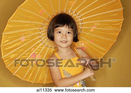 Young girl carrying umbrella, smiling View Large Photo Image Stock Photography - Young girl carrying umbrella, smiling. Fotosearch