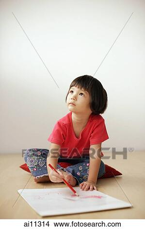 Young girl drawing on drawing pad, looking up View Large Photo Image Picture - Young girl drawing on drawing pad, looking up. Fotosearch