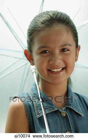 Young girl holding an umbrella View Large Photo Image Picture - Young girl holding an umbrella. Fotosearch