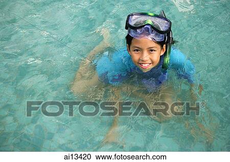 Young girl in swimming pool with goggles, looking up at camera View Large Photo Image Stock Image - Young girl in swimming pool with goggles, looking up at camera. Fotosearch