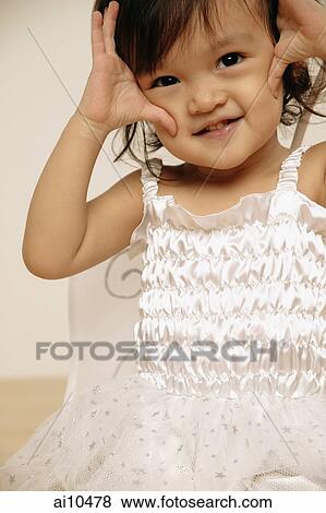 Young girl looking at camera, smiling View Large Photo Image Stock Photo - Young girl looking at camera, smiling. Fotosearch