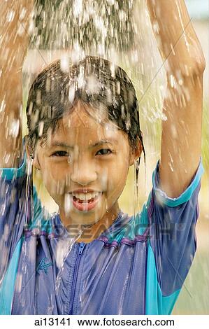 Young girl, looking at camera, water splashing on her head View Large Photo Image Stock Image - Young girl, looking at camera, water splashing on her head. Fotosearch