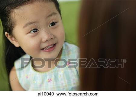 Young girl looking at her mother View Large Photo Image Stock Image - Young girl looking at her mother. Fotosearch