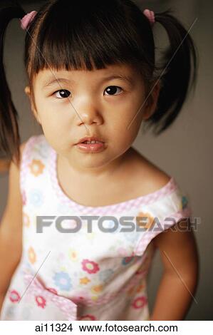 Young girl, looking up at camera, portrait View Large Photo Image Picture - Young girl, looking up at camera, portrait. Fotosearch