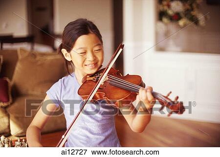Young girl playing the violin at home View Large Photo Image Stock Photo - Young girl playing the violin at home. Fotosearch