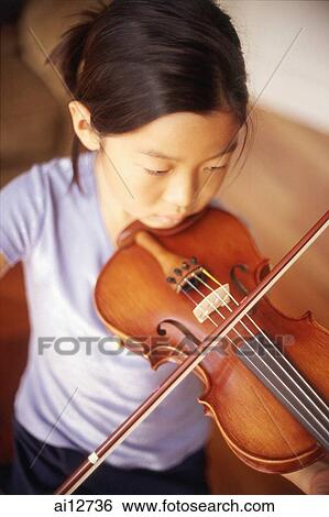 Stock Photograph - Young girl playing the violin. Fotosearch