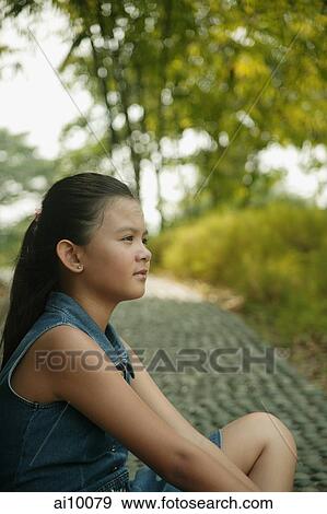 Young girl sitting down, profile View Large Photo Image Stock Photo - Young girl sitting down, profile. Fotosearch