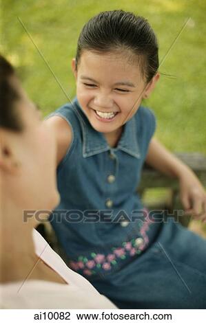 Young girl sitting down with her mother View Large Photo Image Stock Image - Young girl sitting down with her mother. Fotosearch