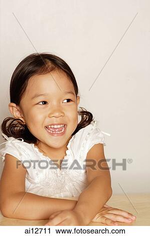 Young girl, smiling, looking away, portrait View Large Photo Image Stock Image - Young girl, smiling, looking away, portrait. Fotosearch