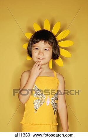 Young girl standing against yellow background, hand on chin View Large Photo Image Stock Image - Young girl standing against yellow background, hand on chin. Fotosearch