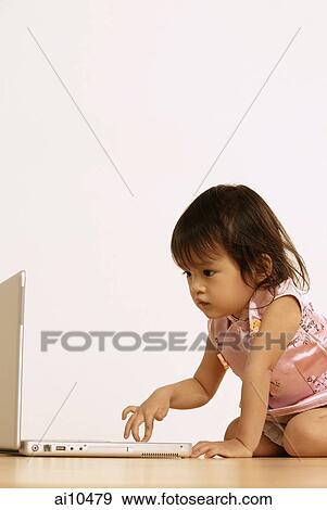 Young girl using laptop View Large Photo Image Stock Photo - Young girl using laptop. Fotosearch