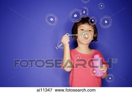 Young girl with bubble wand, blowing bubbles View Large Photo Image Stock Photo - Young girl with bubble wand, blowing bubbles. Fotosearch