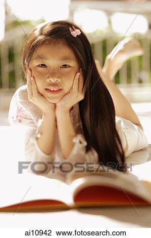 Young girl with hands on chin, looking at camera View Large Photo Image Stock Image - Young girl with hands on chin, looking at camera. Fotosearch