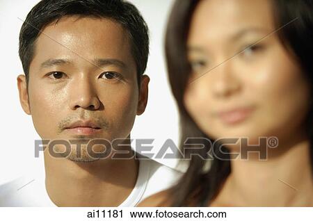 Young man and woman looking at camera View Large Photo Image Stock Image - Young man and woman looking at camera. Fotosearch