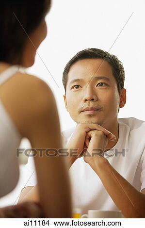 Young man and woman talking, face to face View Large Photo Image Picture - Young man and woman talking, face to face. Fotosearch