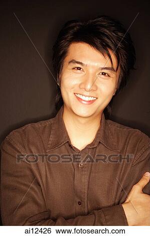 Young man, arms crossed, portrait View Large Photo Image Stock Photograph - Young man, arms crossed, portrait. Fotosearch