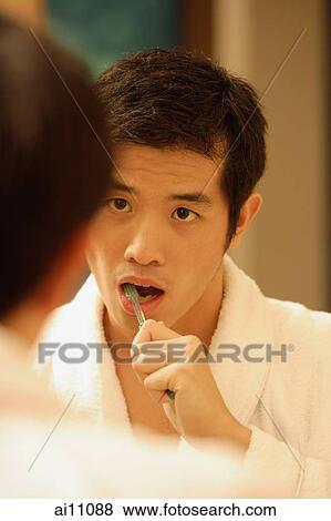 Young man brushing his teeth View Large Photo Image Stock Photo - Young man brushing his teeth. Fotosearch