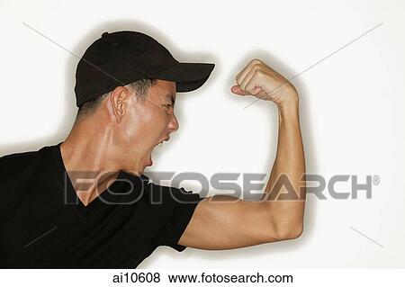 Young man flexing muscles, mouth open View Large Photo Image Stock Photo - Young man flexing muscles, mouth open. Fotosearch