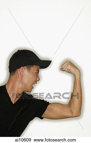 Young man flexing muscles, mouth open View Large Photo Image Stock Photo - Young man flexing muscles, mouth open. Fotosearch