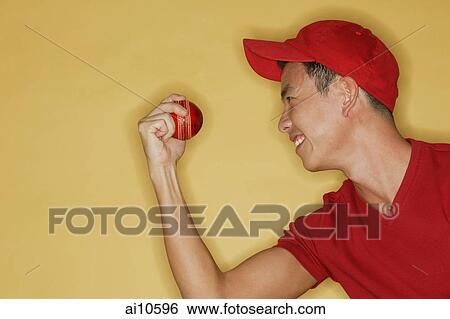 Young man holding a ball, side view View Large Photo Image Stock Photograph - Young man holding a ball, side view. Fotosearch