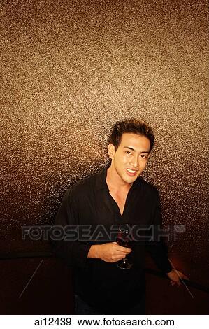 Young man, holding wine glass, looking at camera View Large Photo Image Stock Photo - Young man, holding wine glass, looking at camera. Fotosearch