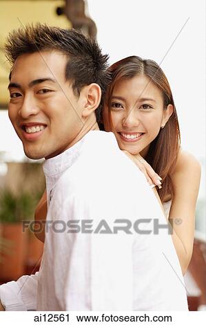 Young man in profile, young woman in front of him, smiling View Large Photo Image Stock Image - Young man in profile, young woman in front of him, smiling. Fotosearch